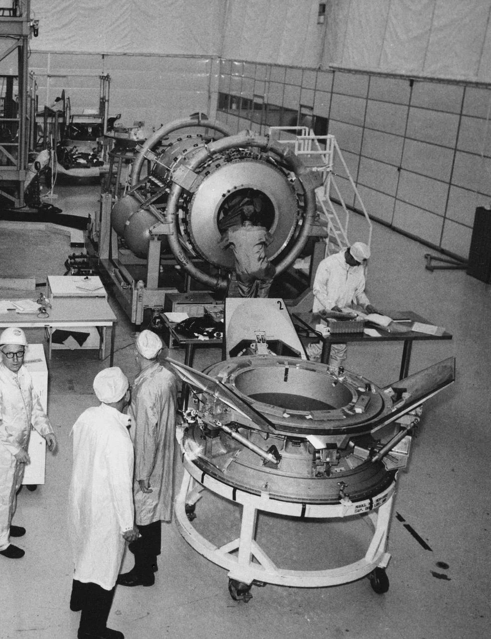 The Apollo–Soyuz docking module and its docking mechanism photographed during preparation at a ground facility.