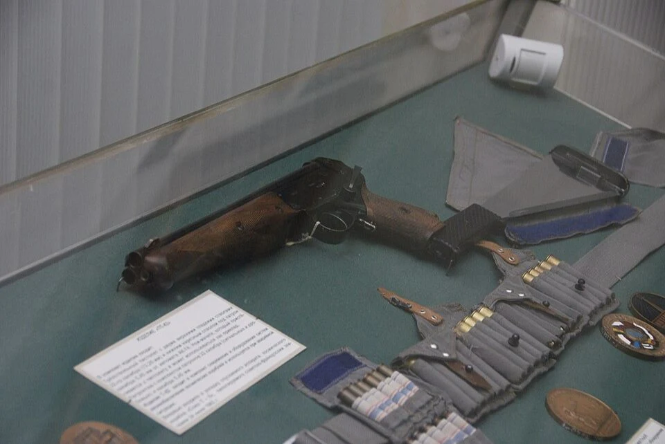 A TP-82 and associated equipment behind glass in a museum display.