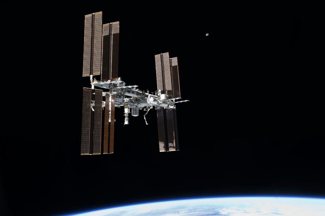 The International Space Station and its solar arrays above Earth.
