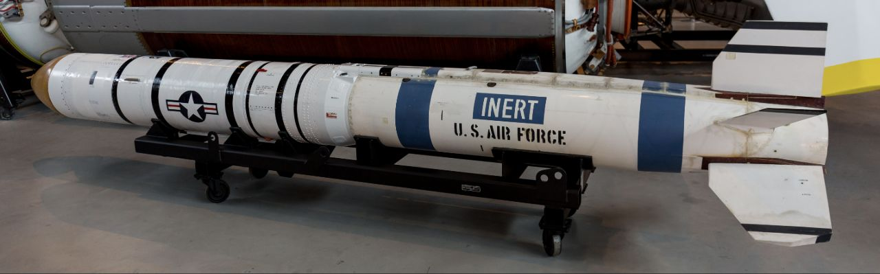 White inert anti-satellite missile on a wheeled museum support.