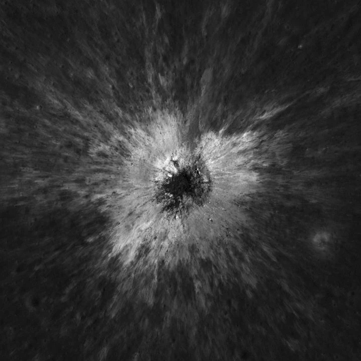 Overhead NAC observation of McGetchin crater with a dark bowl and bright radial ejecta.
