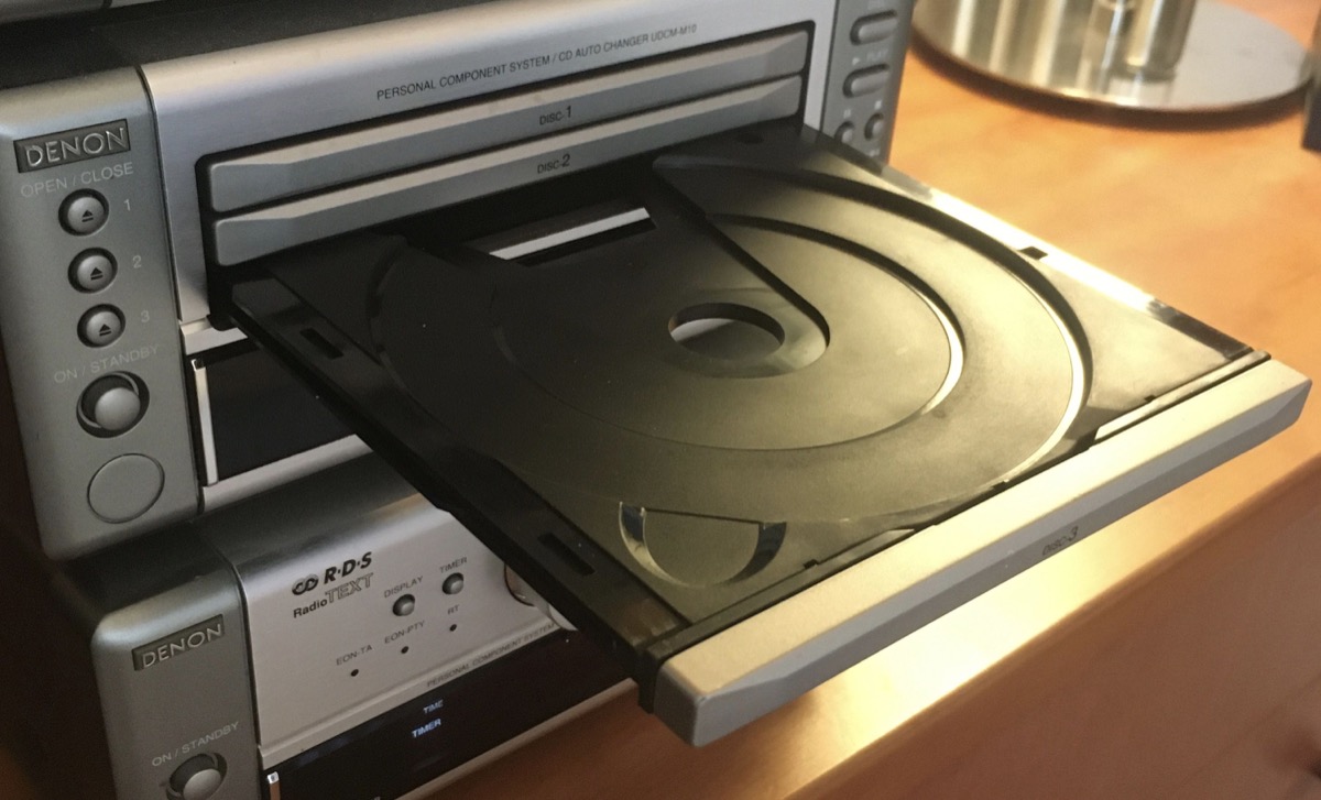 A CD player with an open empty disc tray