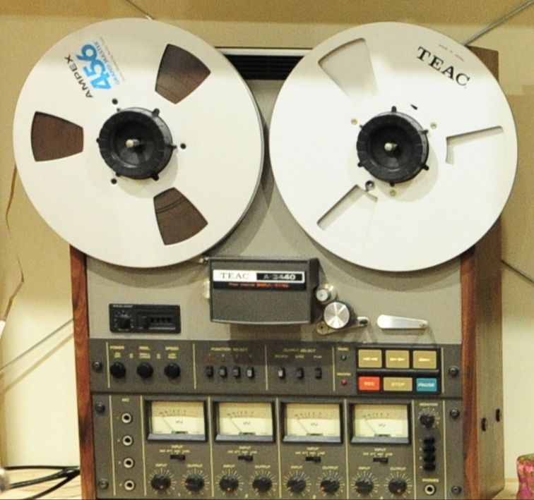 A TEAC four-track reel-to-reel recorder with two reels