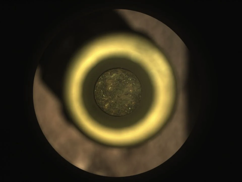 The circular end of Perseverance’s first Martian rock core is visible inside a titanium sample tube.