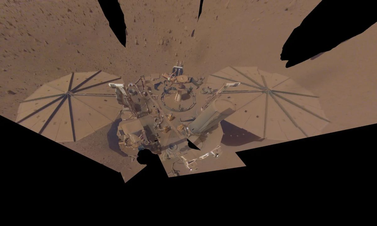InSight lander and circular solar arrays covered by Martian dust.