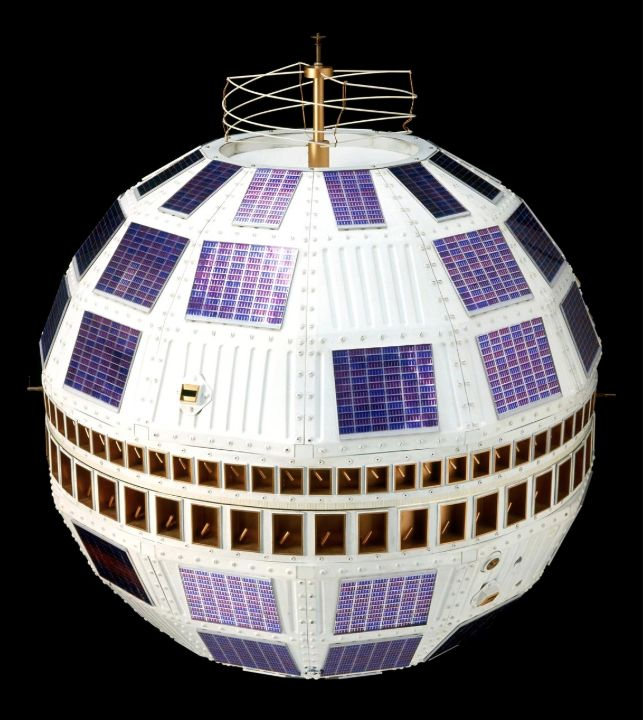 Spherical Telstar satellite replica with blue solar cells and a wire antenna.