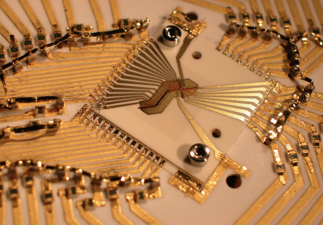A gold-on-alumina ion trap inside a protective case.