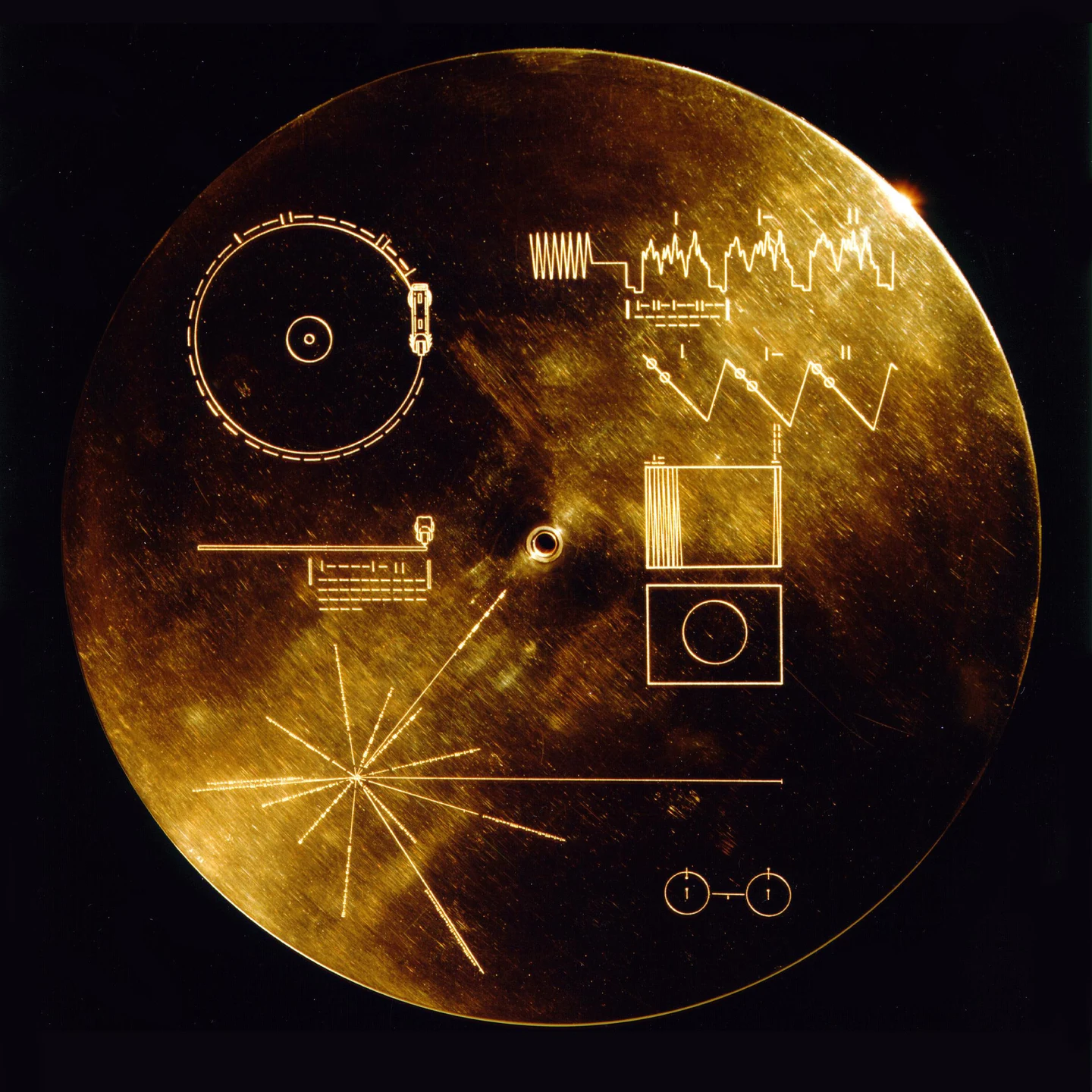 Original Golden Record protective cover, engraved with playback and image diagrams, radial pulsar lines and a hydrogen-atom symbol.